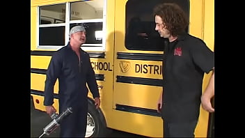 Elder dude in uniform of car mechanic tempts young blonde near the  bus